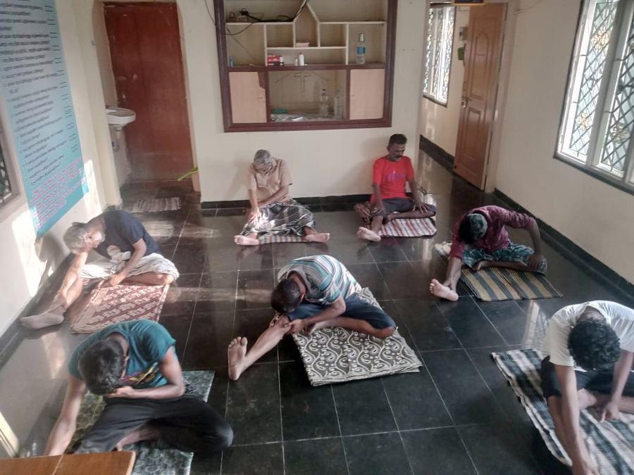 Residents at morning yoga in the therapy hall at Dunamis, Madurai