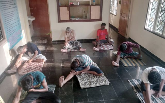 Residents at morning yoga in the therapy hall of the Dunamis rehabilitation centre in Madurai