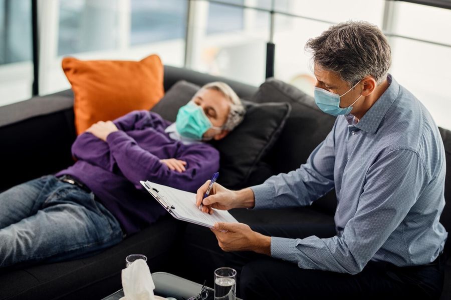 A therapist taking notes during a counselling session